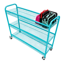A turquoise three-tier wire mesh rolling utility cart with casters, shown on a plain white background with a pink and black bag placed on the top shelf.